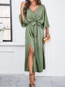 Elegant green V-neck dress featuring a waist tie and slit detail for a refined silhouette
