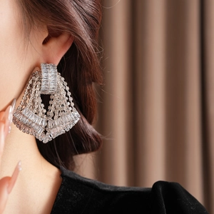 Close-up of sparkling silver bow tassel earrings with cascading crystal rhinestones