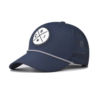 Detailed close-up of dark blue baseball cap with laser-cut ventilation and embroidered patch