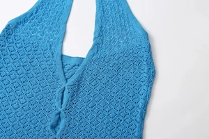 Detailed macro view of bright blue crochet knit halter neck top with hollow-out patterns