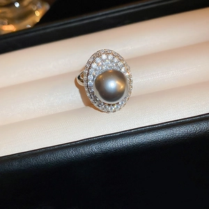 Macro view of grey pearl ring with double zircon pavé halo on silver band