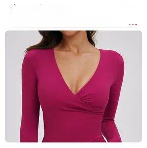 Detail showing the crossover V-neck design on a rose red long sleeve yoga shirt