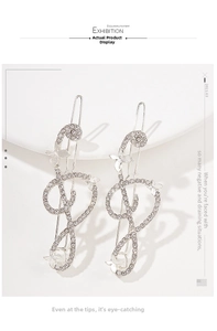 Detailed macro view of rhinestone-encrusted musical note hairpins on a white tray