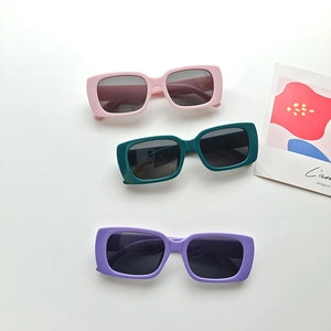 Three pairs of vintage square kids sunglasses in pink, green and purple colors