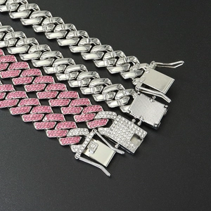 Close-up of three layered Cuban chains with pink rhinestones and silver metal finish