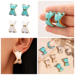 Macro detail of sky blue and pearl white enamel C-shaped earrings with 18k gold plating