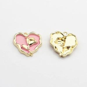 Detailed view of pink enamel heart charms with golden rose motif for DIY jewelry making