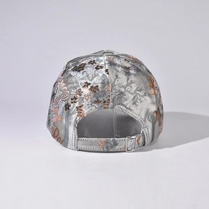 Detail of adjustable metal buckle and floral jacquard texture on gray baseball cap