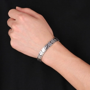 Detailed close-up of a masculine silver V-shaped keel chain link bracelet on a wrist