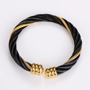 Detail of black steel cable weave bracelet with gold-plated stainless steel accents