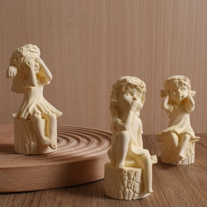 Detailed trio of girl figurines on wood stumps in see-no-evil speak-no-evil pose