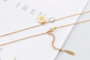 Macro view of golden pendant necklace with extension chain and K14 hallmark detail