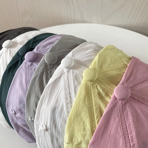 Close-up of quick-dry nylon baseball caps in various colors showing stitch detail