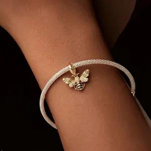 Exquisite gold-plated bee charm with sparkling crystals on a silver mesh bracelet