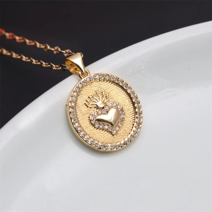 Golden Sacred Heart pendant necklace with crown and sparkling cubic zirconia stones