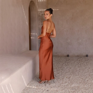 Detail of the open back and draped satin fabric of this caramel maxi dress