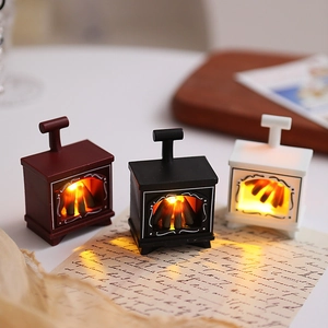 Cozy group shot of mini LED fireplace lanterns in black, white, and bronze finishes