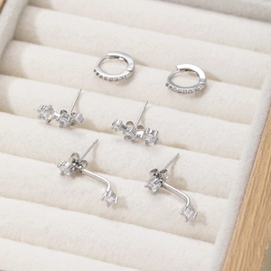 Detailed view of 3-piece silver zircon earring set on premium beige velvet lining