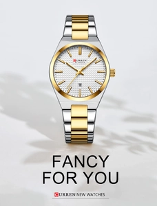 Detail of Curren Blanche silver and gold quartz watch with date display on gray background