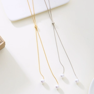 Adjustable pearl lariat necklace with minimalist gold and silver snake chains