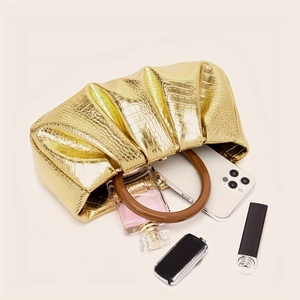 Golden dumpling bag with resin ring handle showing interior storage capacity