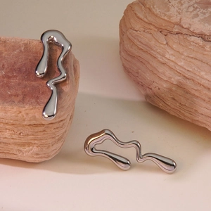 Silver lava irregular liquid metal stud earrings displayed on natural stone background