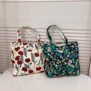 Detail of floral cotton lunch bags in beige and navy patterns with simple wish labels