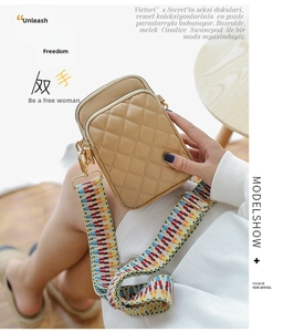 Detail of quilted crossbody phone bag with colorful jacquard strap and gold hardware
