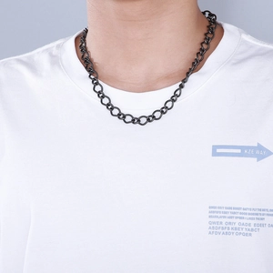 Close-up of a 10mm minimalist black stainless steel chain necklace on a male model
