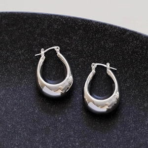 Polished silver water drop hoop earrings with a high-shine mirror finish in minimalist style