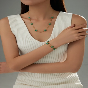 Detail of gold floral necklace and double-layer bracelet set with turquoise beads