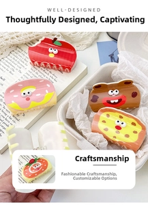 Detail shot of cute acrylic animal and fruit hair claws with fun cartoon 3D eye designs