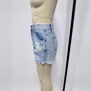 Close-up of light blue distressed denim shorts featuring frayed hems and side rip details
