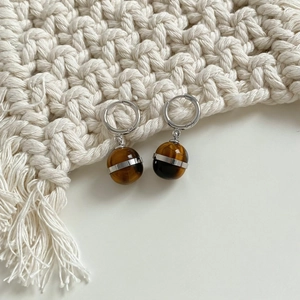Elegant tiger eye stone ball earrings with silver hoops and metallic strip details