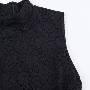 Detailed close-up of high-neck black lace dress featuring fine mesh and a metal zipper back