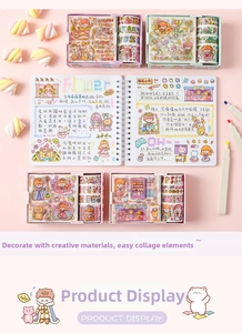 Detail of pink cartoon stationery set with decorated journal and washi tape rolls