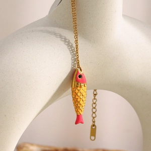 18K gold-plated stainless steel necklace with pink enamel fish pendant on white mannequin
