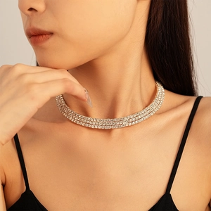 Close-up of triple-layered silver choker necklace with shimmering square-cut crystals