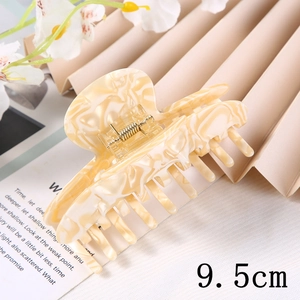 Detail shot of 9.5cm marble pattern hair claw clip with cream and white swirls