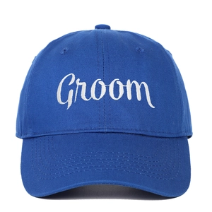 Close-up of royal blue cotton baseball cap with white Groom embroidery detail