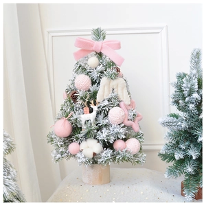 Macro shot of a 45cm mini pink Christmas tree with soft wool balls and a wooden base