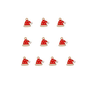 Flat lay of 10 red enamel Christmas hat charms with gold trim and crystal rhinestones