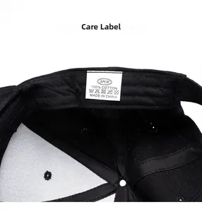 Detail view of the black baseball cap showing 100% cotton wash label and inner stitching