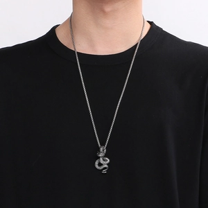 Gothic punk snake pendant necklace in silver stainless steel on male model wearing black tee
