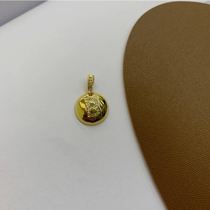 Macro shot of 18K gold-plated round pendant with sparkling zircon initial B detail