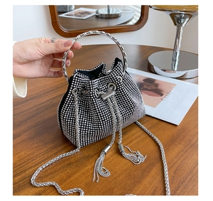 Detail of black mini bucket bag with sparkling silver rhinestones and metal ring handle