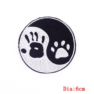 Detail view of 6cm round Yin Yang embroidery patch with hand and paw prints