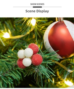 Detail of frosted red and white Christmas berry picks hanging on a festive tree branch