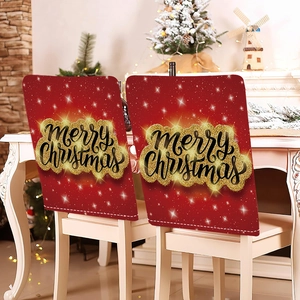 Detail of red Christmas chair covers featuring golden glitter Merry Christmas text and stars