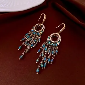 Ethnic bohemian gold tassel earrings with oval crystals and sparkling zircons